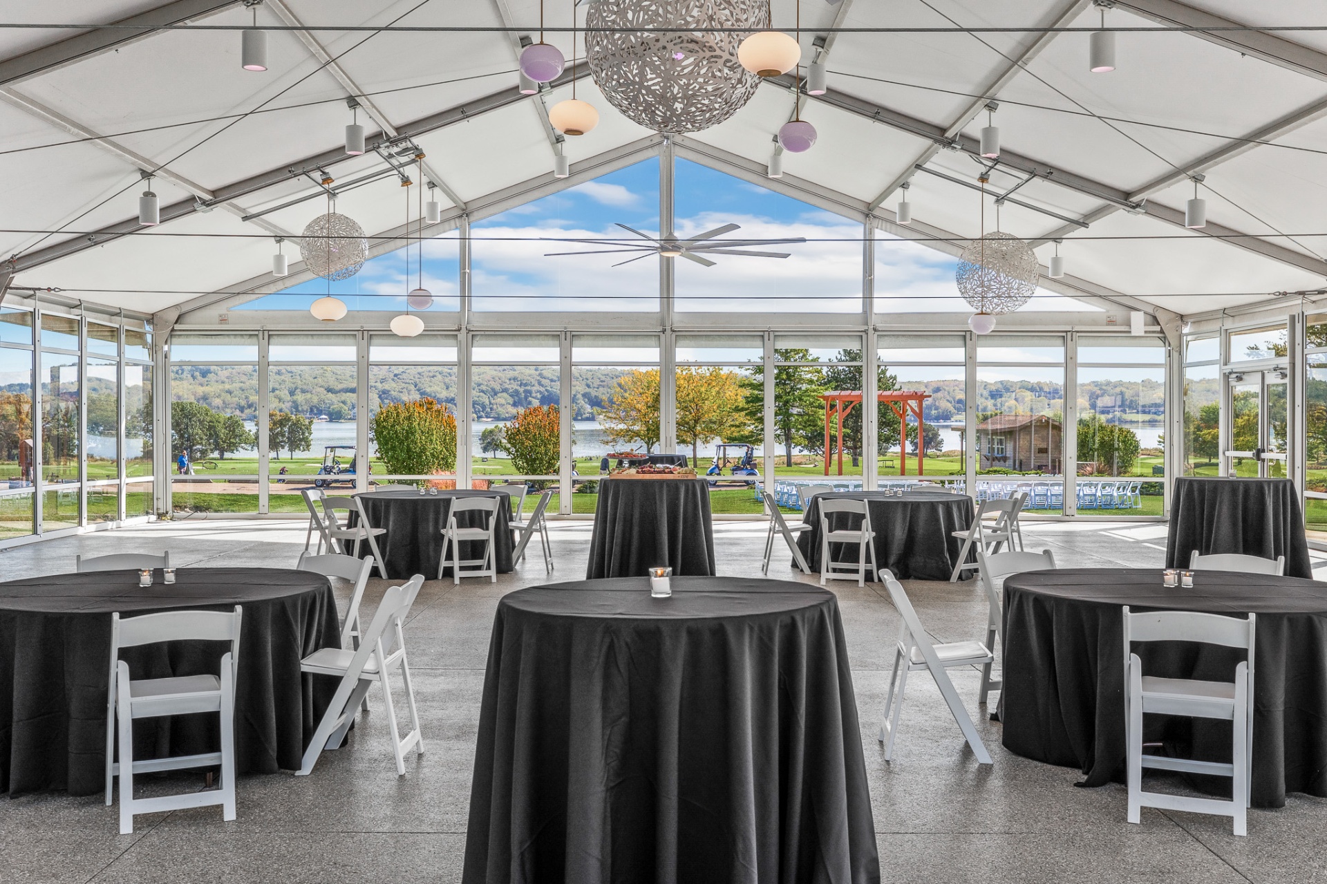 Tent interior overlooking Lake Como through floor-to-ceiling glass