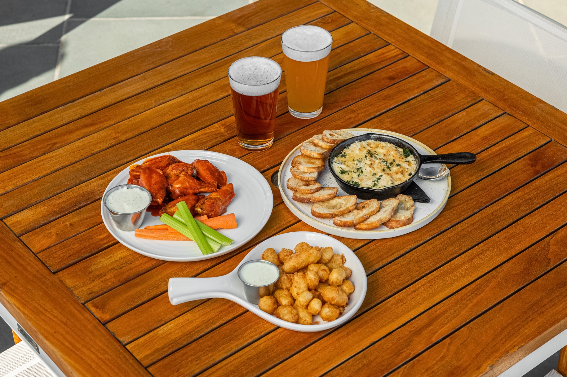 Buffalo wings, cheese curds and beer on the patio