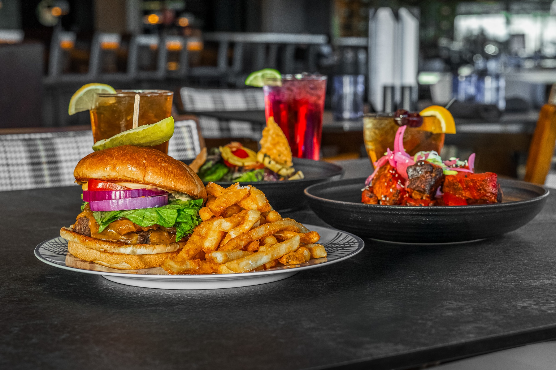 Burger, fries and cocktails on the bar