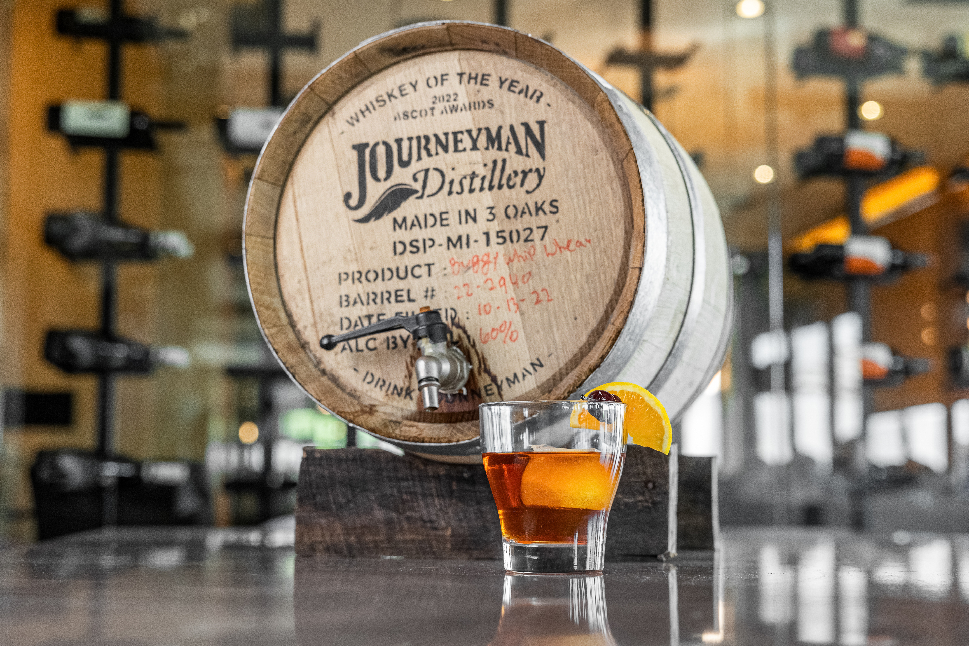 Journeyman Distillery barrel with an old fashioned cocktail
